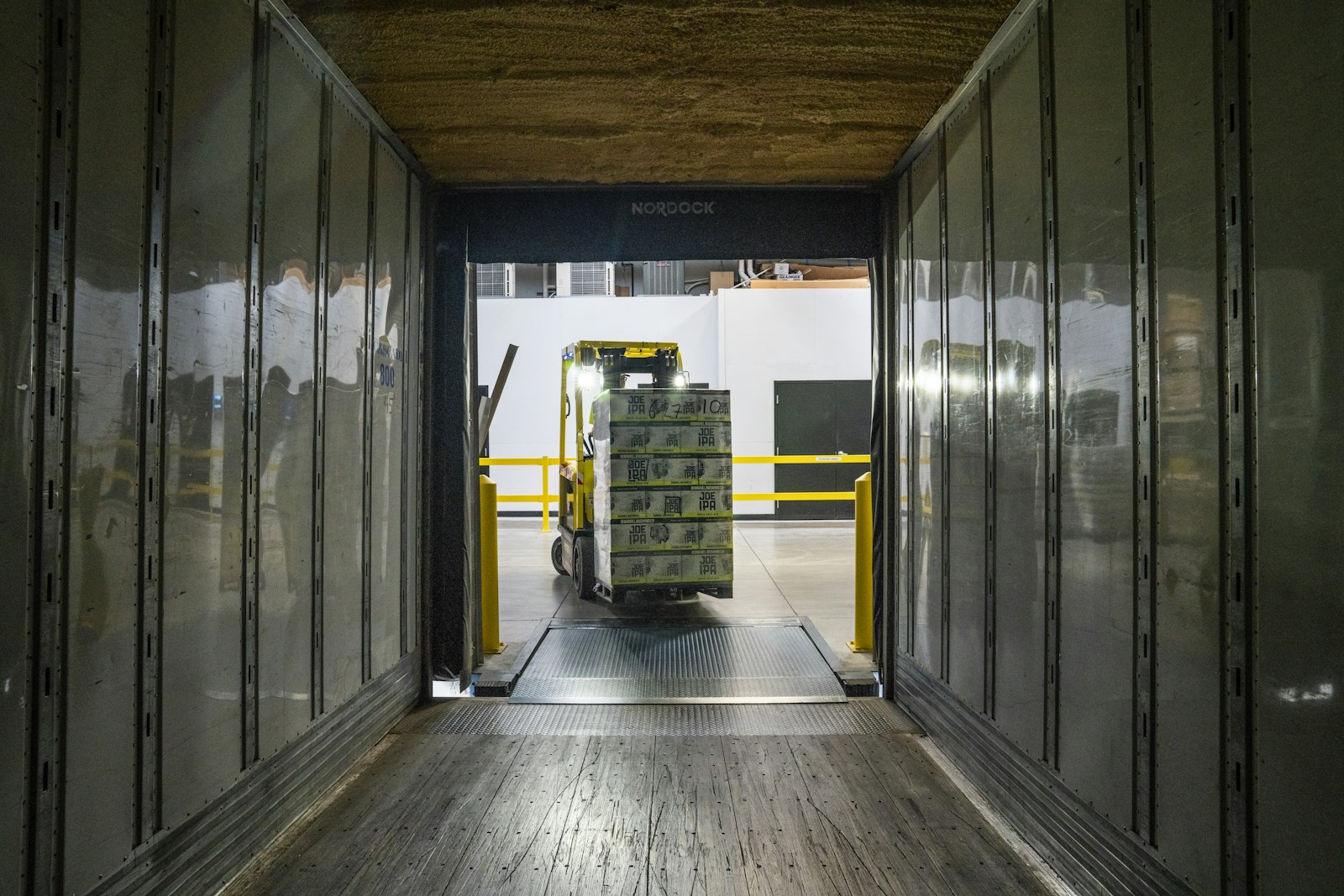 A delivery truck inside a warehouse